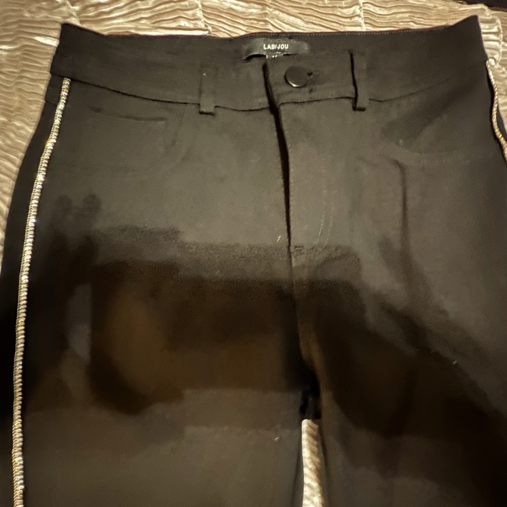 Black with rhinestones on sides.  Really adorable pants size medium. Never worn